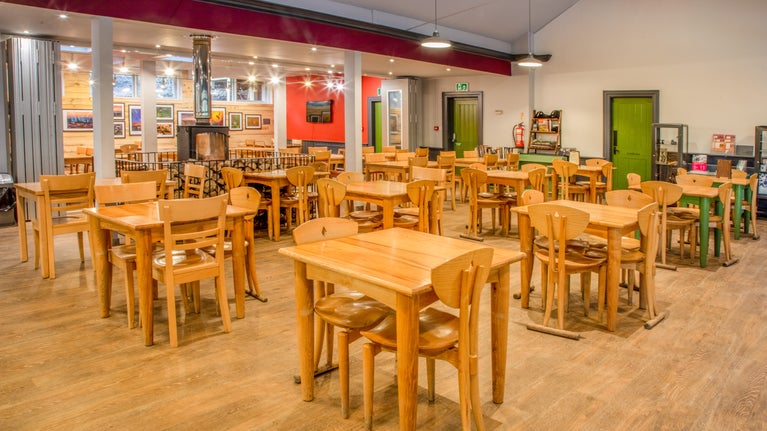 Cosy tea room with real fire in the centre.